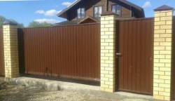 Забор с откатными воротами с автоматикой и кирпичными столбами. Высота 2м.